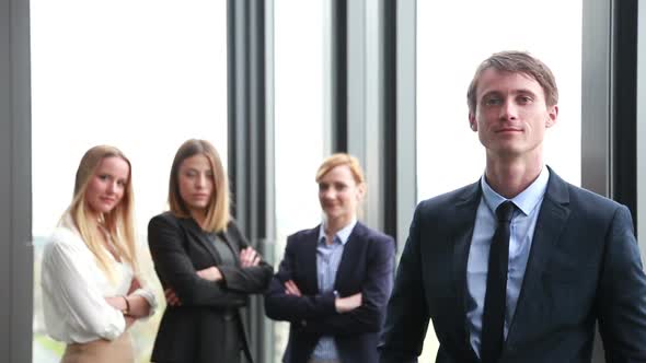 Portrait Of Handsome Businessman, Female Colleagues In Background 1