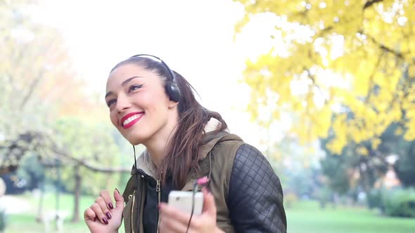 Young Woman Listening To Music On Headphones And Dancing 1