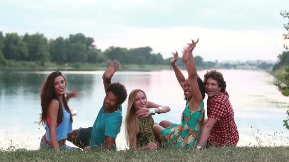 Back View Of Group Of Friends, Turning Around And Waving To Camera 2