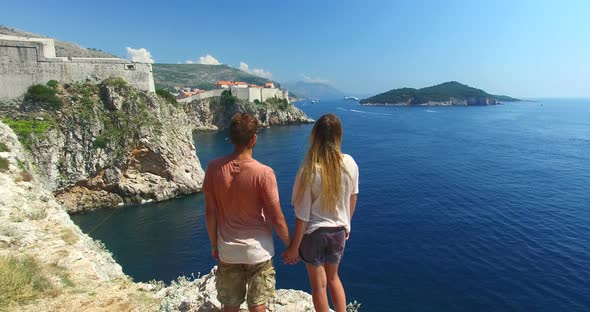 Couple Holding Hands On A Cliff With A View Of Old Town Of Dubrovnik 4