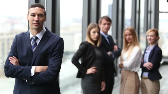 Portrait Of Young Director, Colleagues In Background