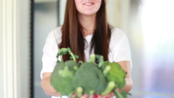 View Of Woman Hands Holding Bunch Of Broccoli
