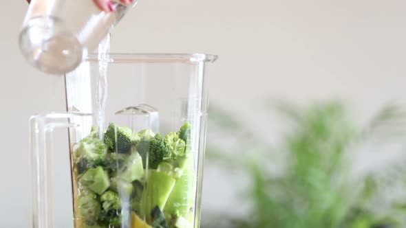 Pouring Water In Blender With Fruits And Vegetables 1