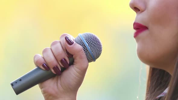 View Of Woman's Mouth With Red Lipstick, Smiling And Singing With Microphone 4