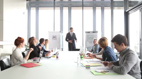 Handsome Director Pointing At Flipchart During A Meeting 3