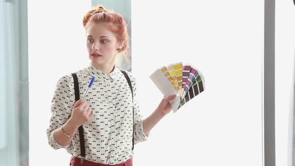 Beautiful Red Hair Woman Holding Color Fan Deck During Presentation