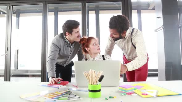 Red Hair Woman Discussing New Ideas On Laptop With Male Colleagues 1