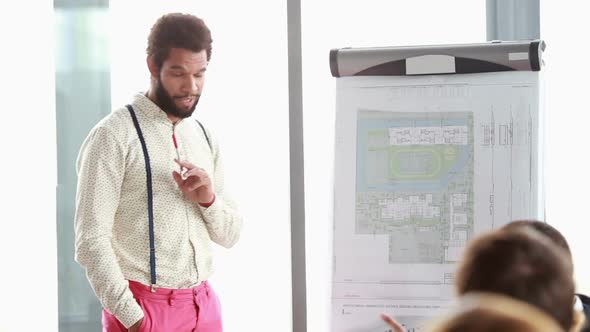 Handsome Man Giving Presentation To His Colleagues