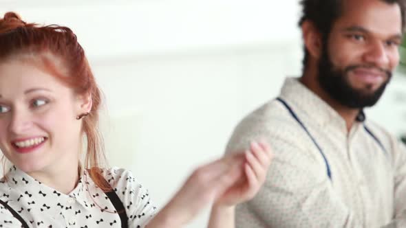 Woman Applauding During Presentation, Male Colleague In Background