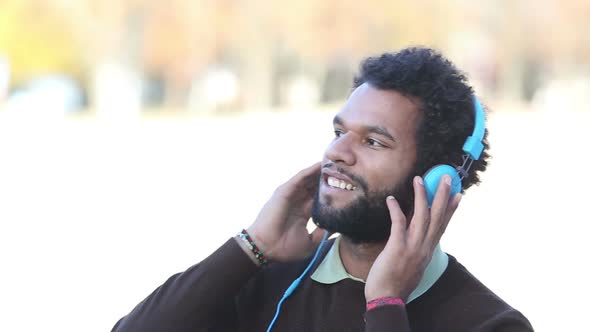 Handsome Man Putting On Headphones And Listening To Music 1