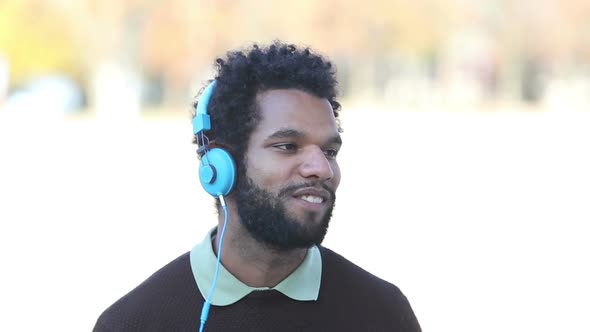 Handsome Man Putting On Headphones And Listening To Music 2