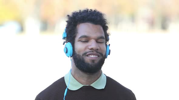 Handsome Man Putting On Headphones And Listening To Music 3