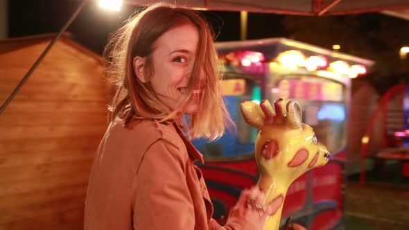 Beautiful Woman Having Fun Riding Carousel In Amusement Park 1