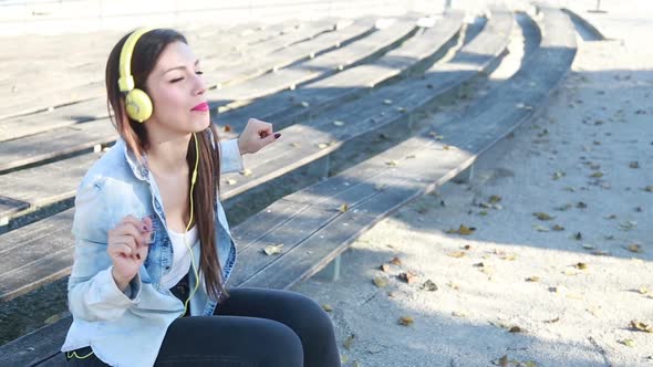 Beautiful Woman Listening To Music On Headphones And Dancing To The Rhythm 1