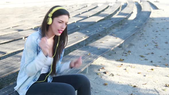 Beautiful Woman Listening To Music On Headphones And Singing