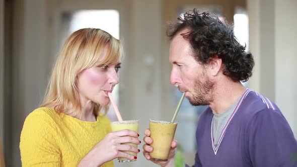 Happy Couple Toasting And Drinking Fruit Smoothie 1