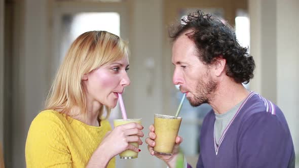 Happy Couple Toasting And Drinking Fruit Smoothie 2