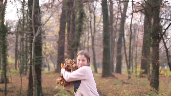 Happy Girl Having Fun Throwing Leaves In The Air 2