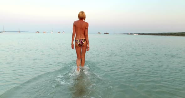 Woman Entering Into Sea At Slatinica Beach, Croatia 4