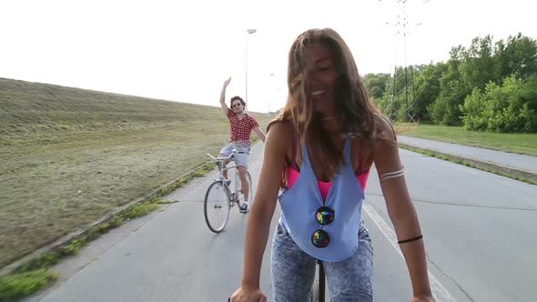 Beautiful Woman Sending Kisses While Cycling With Friends 2