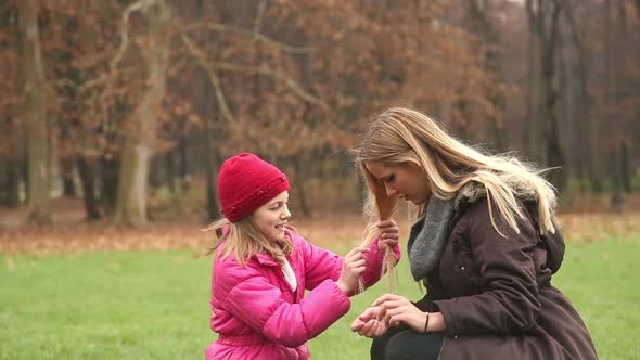 Little Girl Playing With Her Mother's Hair