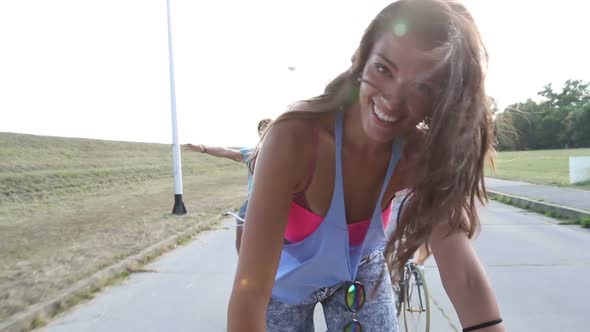 Beautiful Woman Sending Kisses While Cycling With Friends 7