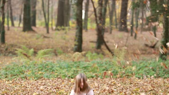 Lovely Girl Throwing Leaves And Jumping In Park