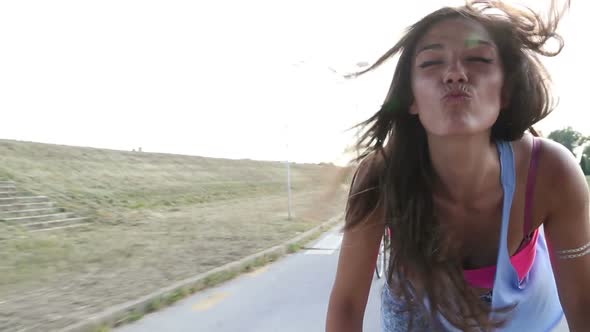 Beautiful Woman Sending Kisses While Cycling With Friends 8