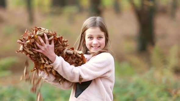 Cute Girl Throwing Leaves In Park 1