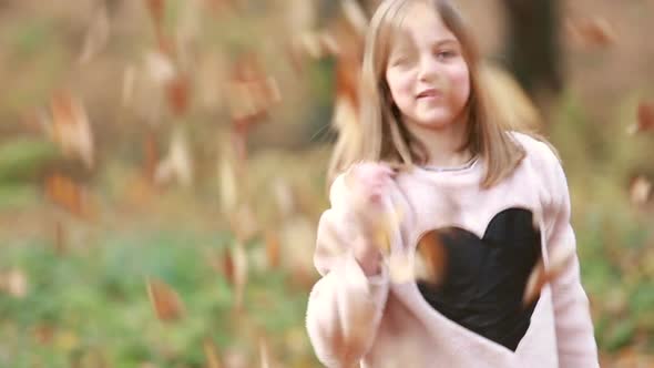 Cute Girl Throwing Leaves In Park 2