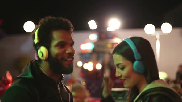Man And Woman Dancing To The Rhythm Of Music With Headphones 4