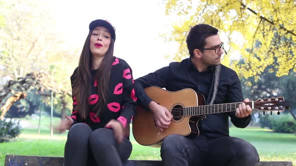 Beautiful Woman Singing While Handsome Man Playing Guitar 5