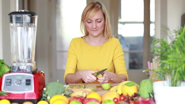 Woman Peeling Skin Off Kiwifruit 3