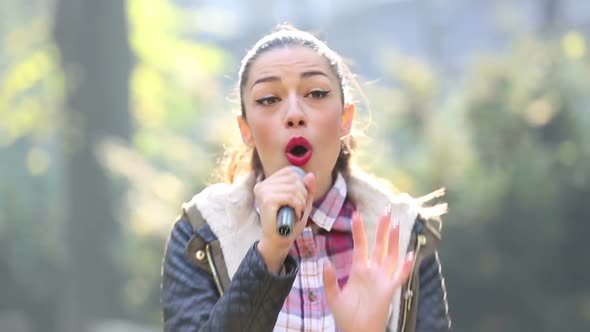 Beautiful Woman Singing With The Microphone 2