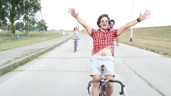 Three Young Adults Having Fun Cycling 2