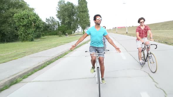 Three Young Adults Having Fun Cycling 3