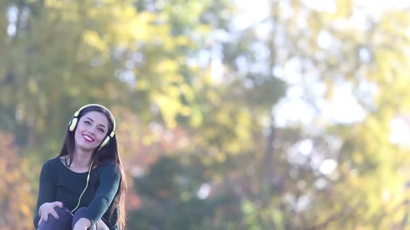 Woman Sending Kiss To Camera While Listening To Music With Headphones 2