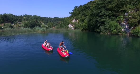 Aerial View Of Friends Having Fun Paddling Canoe 2