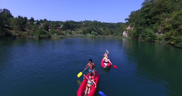 Aerial View Of Friends Having Fun Paddling Canoe 3