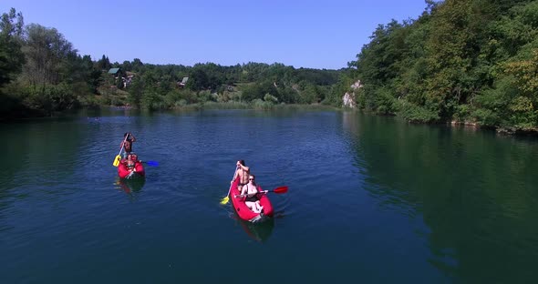 Aerial View Of Friends Having Fun Paddling Canoe 5