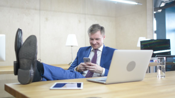 Text Messaging on Phone, Positive Relaxing Businessman