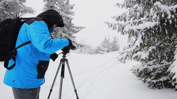 Photographer In Winter Mountain