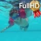 a Little Boy Dives Under the Water in the Pool - VideoHive Item for Sale