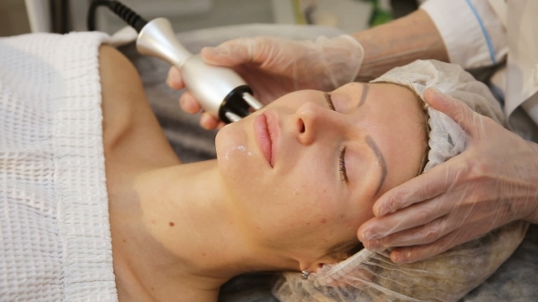 Young Woman Receiving Electric Facial Massage