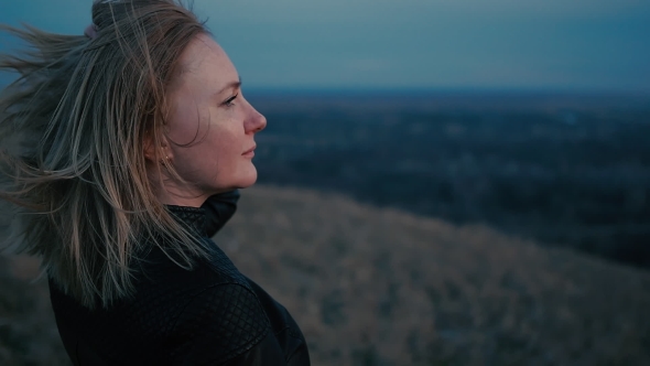 Beautiful Girl Watching The Sunset And Smiling, Hair In The Wind