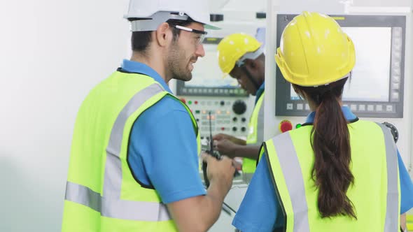 Group of worker people wearing protective safety equipment helmet and glasses in production factory