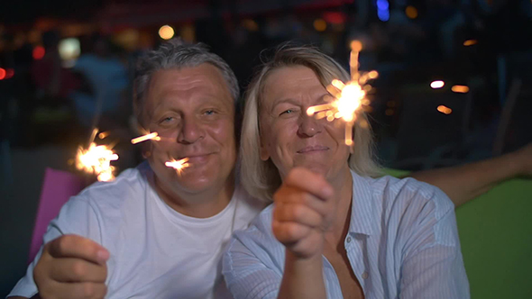 Happy Senior Man And Woman With Sparklers