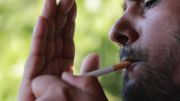 Dark Indian Man Smoking A Cigarette