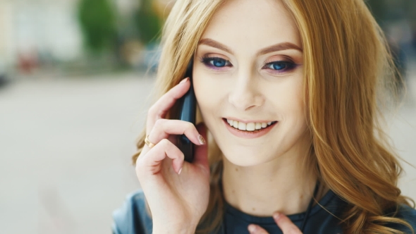 Young Woman Talking On The Phone, Smiling, Flirting