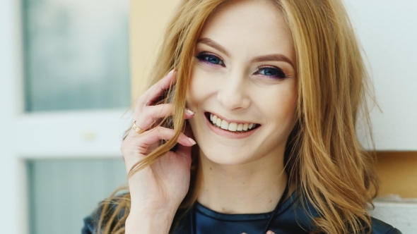 Beautiful Blue-eyed Woman Speaks On a Mobile Phone